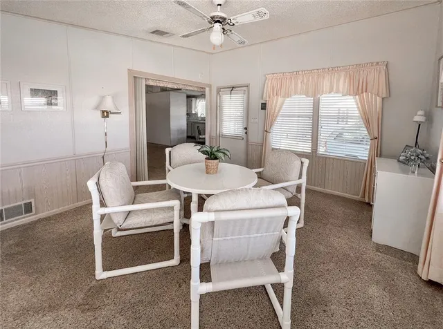a dining room with furniture and window