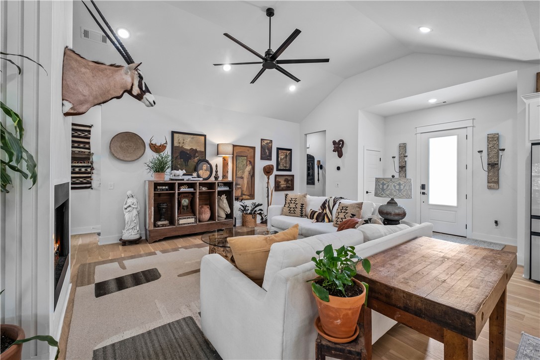 Vaulted ceilings with recessed lighting and a large ceiling fan