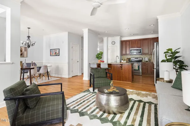 a living room with dining room and wooden floor