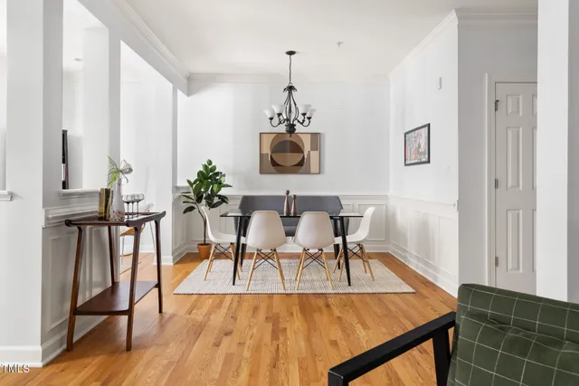 a dining room with furniture and wooden floor