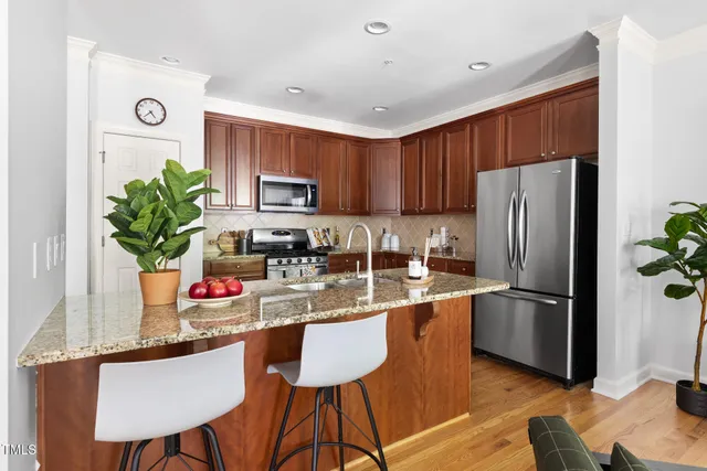 a kitchen with granite countertop stainless steel appliances and wooden cabinets