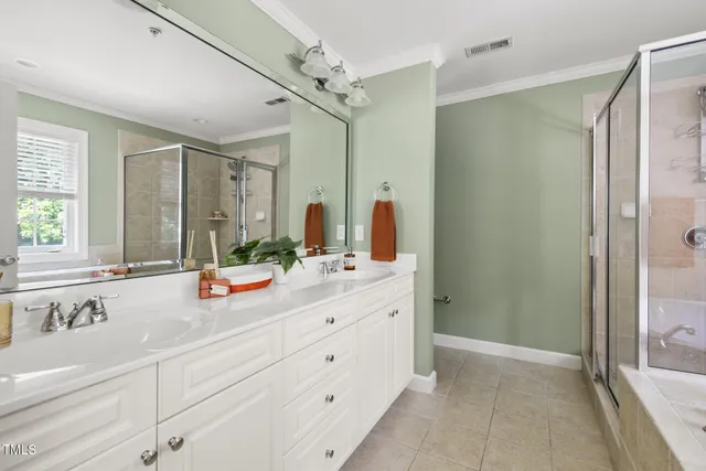 a bathroom with a double vanity sink mirror double and shower