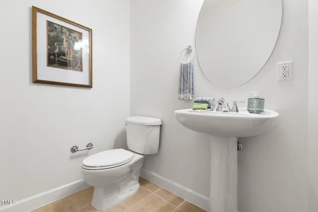 a bathroom with a sink mirror and toilet