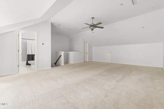 a view of empty room with ceiling fan