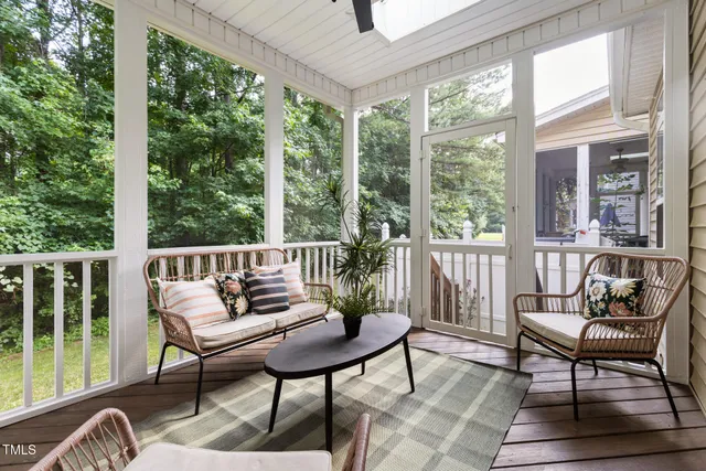 a view of a chairs and table in patio with wooden floor