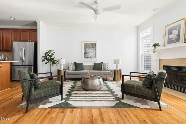 a living room with furniture a large window and a fireplace