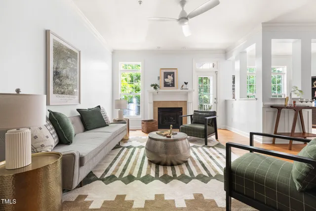 a living room with furniture a large window and a fireplace