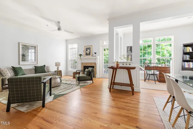 a living room with furniture a wooden floor and a fireplace