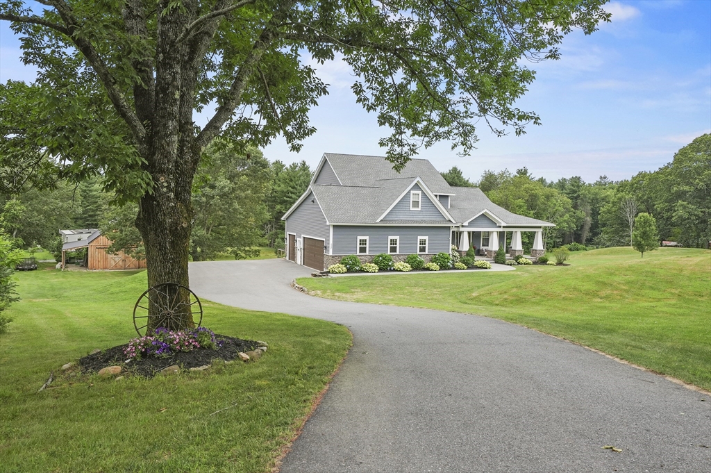 112 Nourse Road Bolton, MA 01740 - Photo 1 of 42 a front view of a house with garden