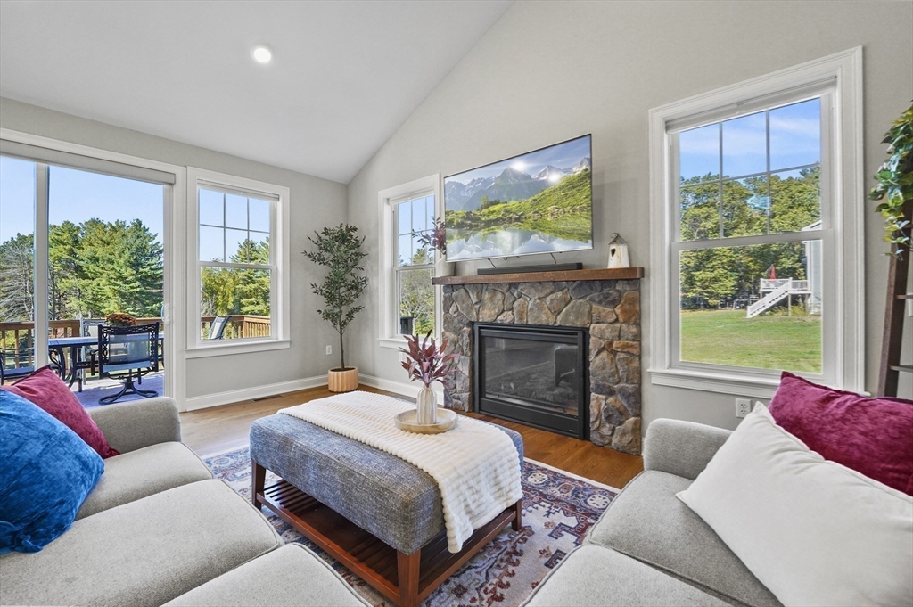 112 Nourse Road Bolton, MA 01740 - Photo 17 of 42 a bedroom with a large bed and a fireplace