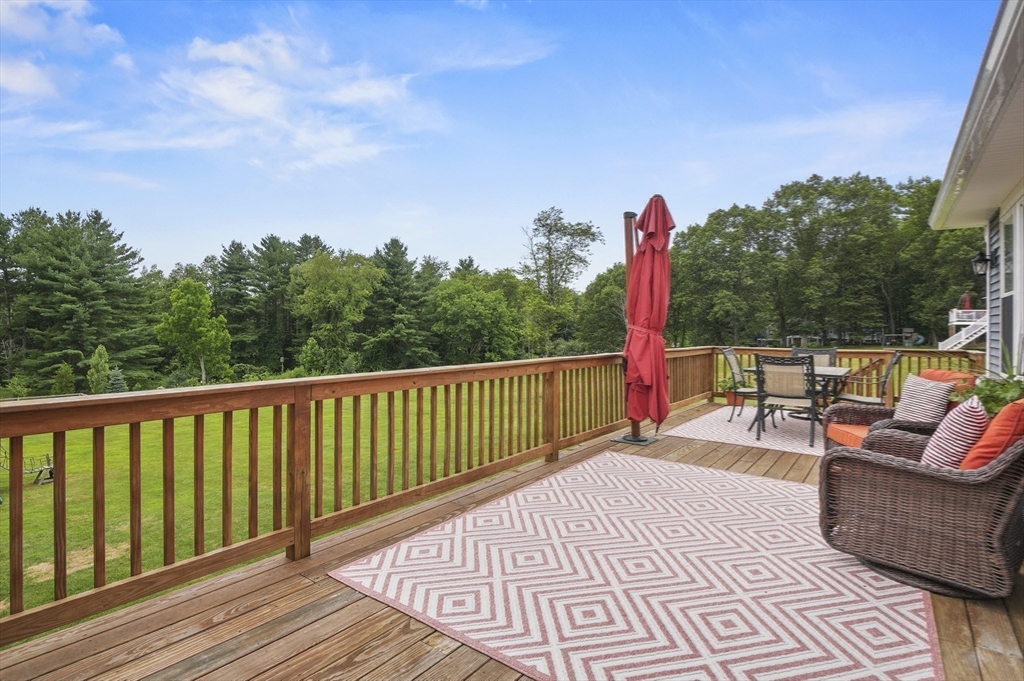 112 Nourse Road Bolton, MA 01740 - Photo 34 of 42 a view of a balcony with wooden floor and outdoor seating