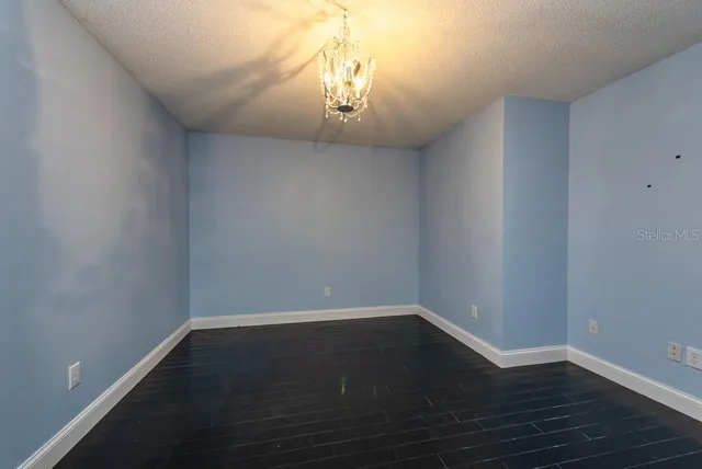 a view of a room with wooden floor and a window