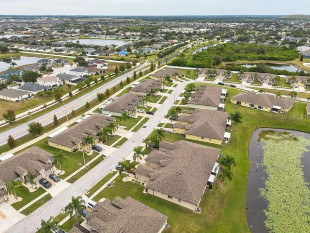 an aerial view of residential houses with outdoor space