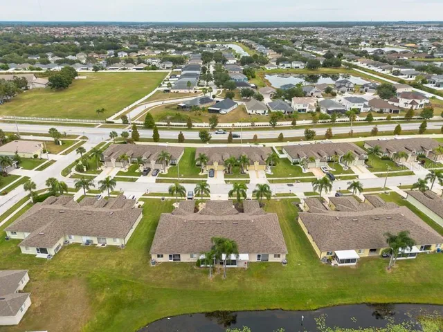 an aerial view of residential houses with outdoor space