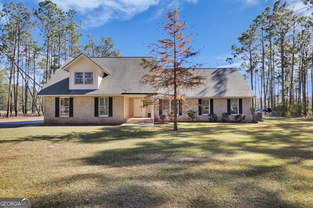 a front view of a house with a garden