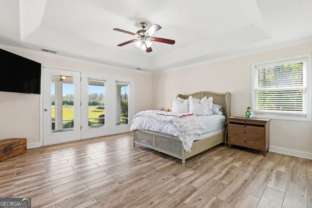 a bedroom with furniture and a wooden floor