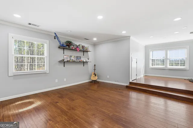 a front view of a house with a yard and trees