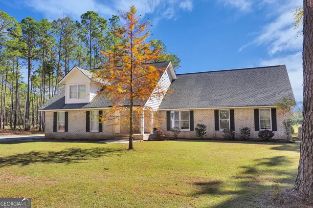 a front view of a house with a garden