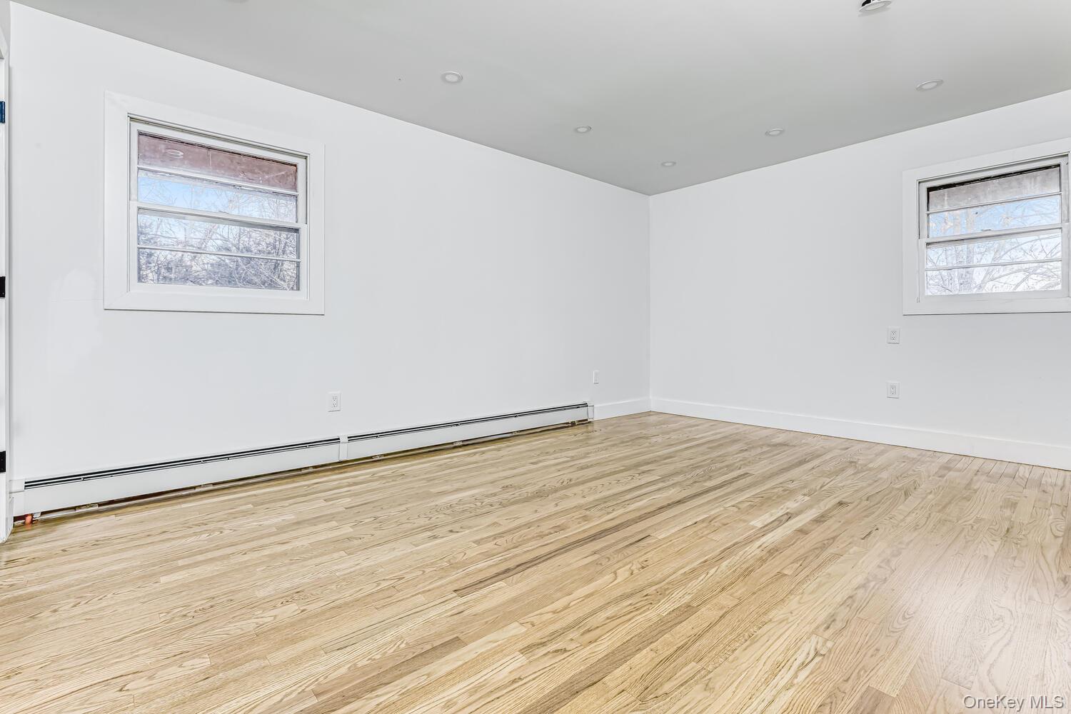 3 Camp Hill Road Pomona, NY 10970 - Photo 12 of 26 an empty room with wooden floor and windows