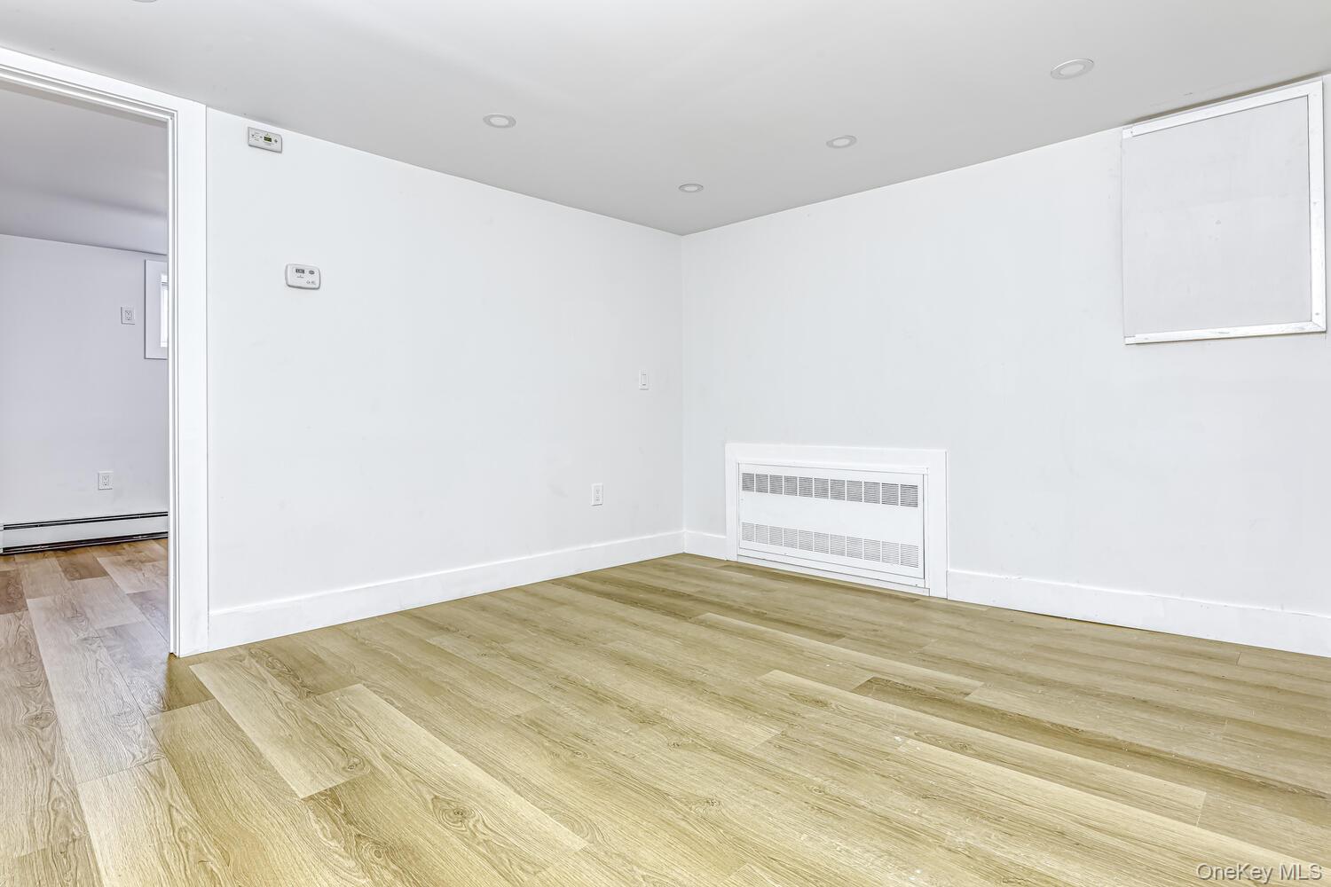 3 Camp Hill Road Pomona, NY 10970 - Photo 20 of 26 Spare room with a baseboard radiator, wood finished floors, radiator heating unit, and baseboards
