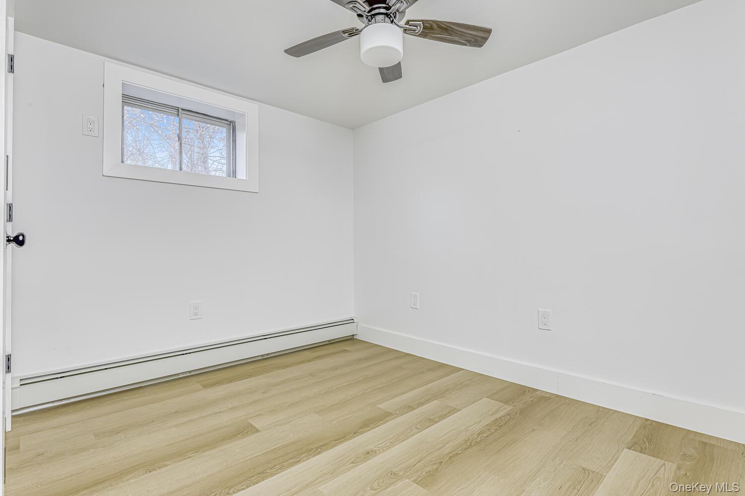 3 Camp Hill Road Pomona, NY 10970 - Photo 22 of 26 an empty room with a window and a ceiling fan