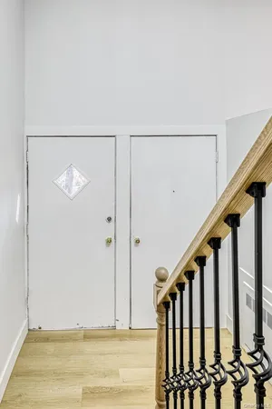 a view of staircase with railing and white walls