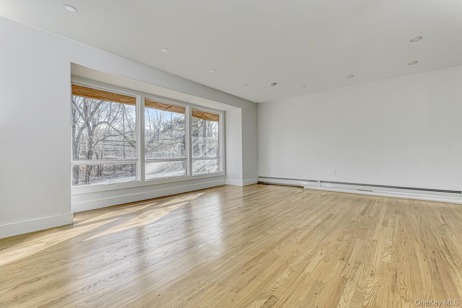 3 Camp Hill Road Pomona, NY 10970 - Photo 7 of 26 a view of an empty room with wooden floor and a window