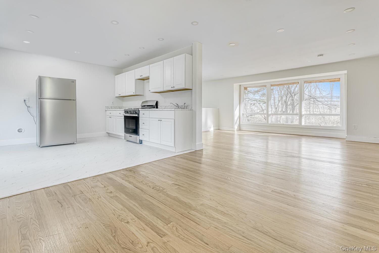 3 Camp Hill Road Pomona, NY 10970 - Photo 24 of 26 an empty room with wooden floor and fireplace