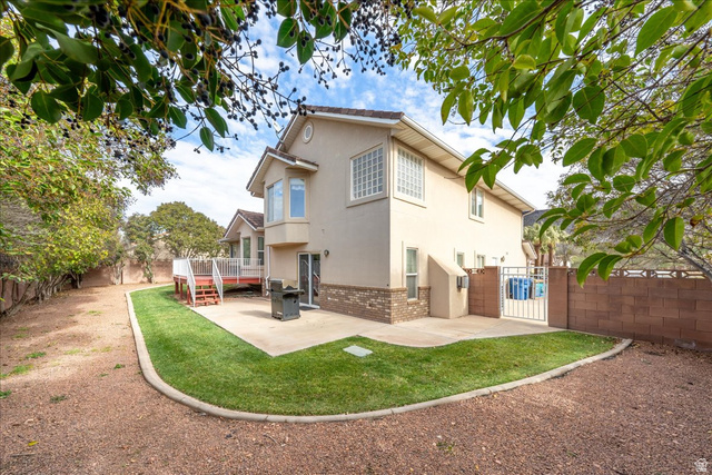 7 Reflection Way St. George, UT 84770 - Photo 48 of 54 Back of property featuring brick siding, a patio, a fenced backyard, and a gate