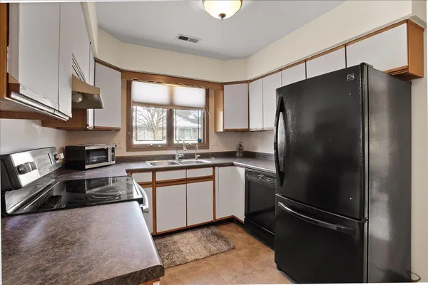a kitchen with a refrigerator and a sink