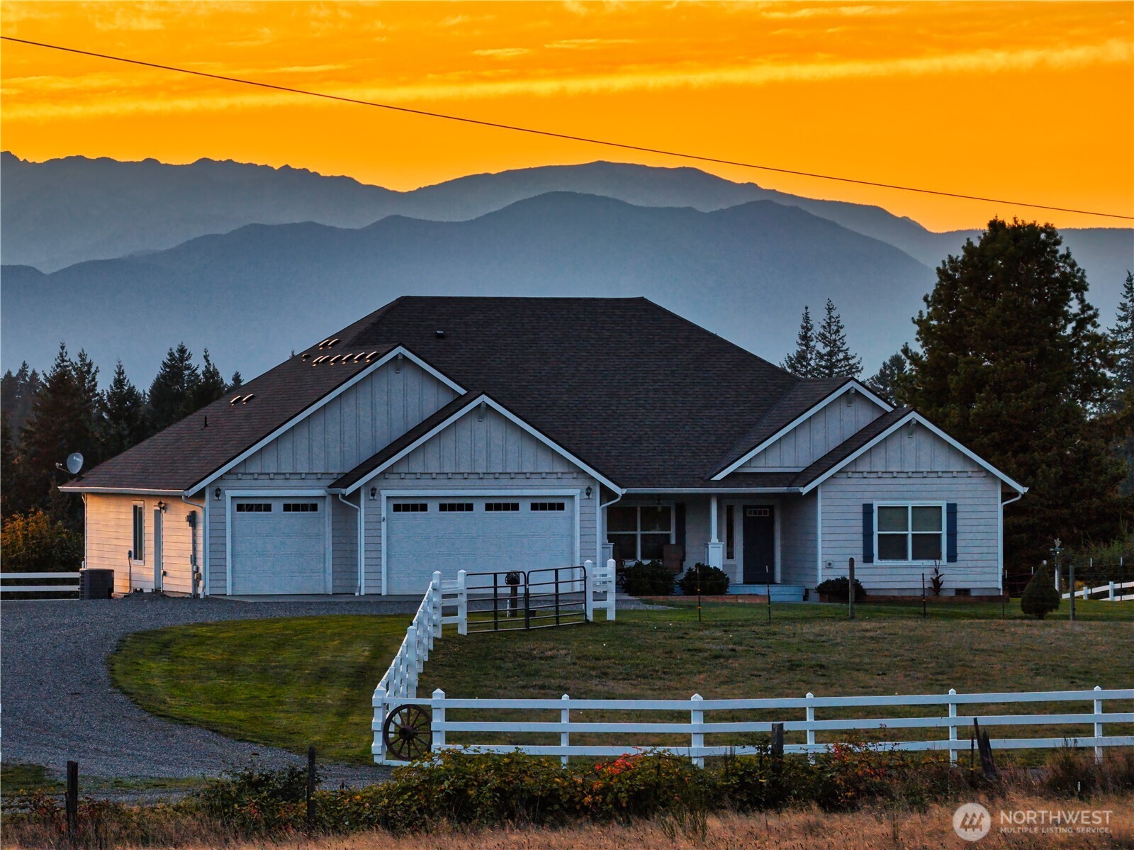 25965 Tytler Road Northeast Poulsbo, WA 98370 - Photo 2 of 40 a view of a house with a yard