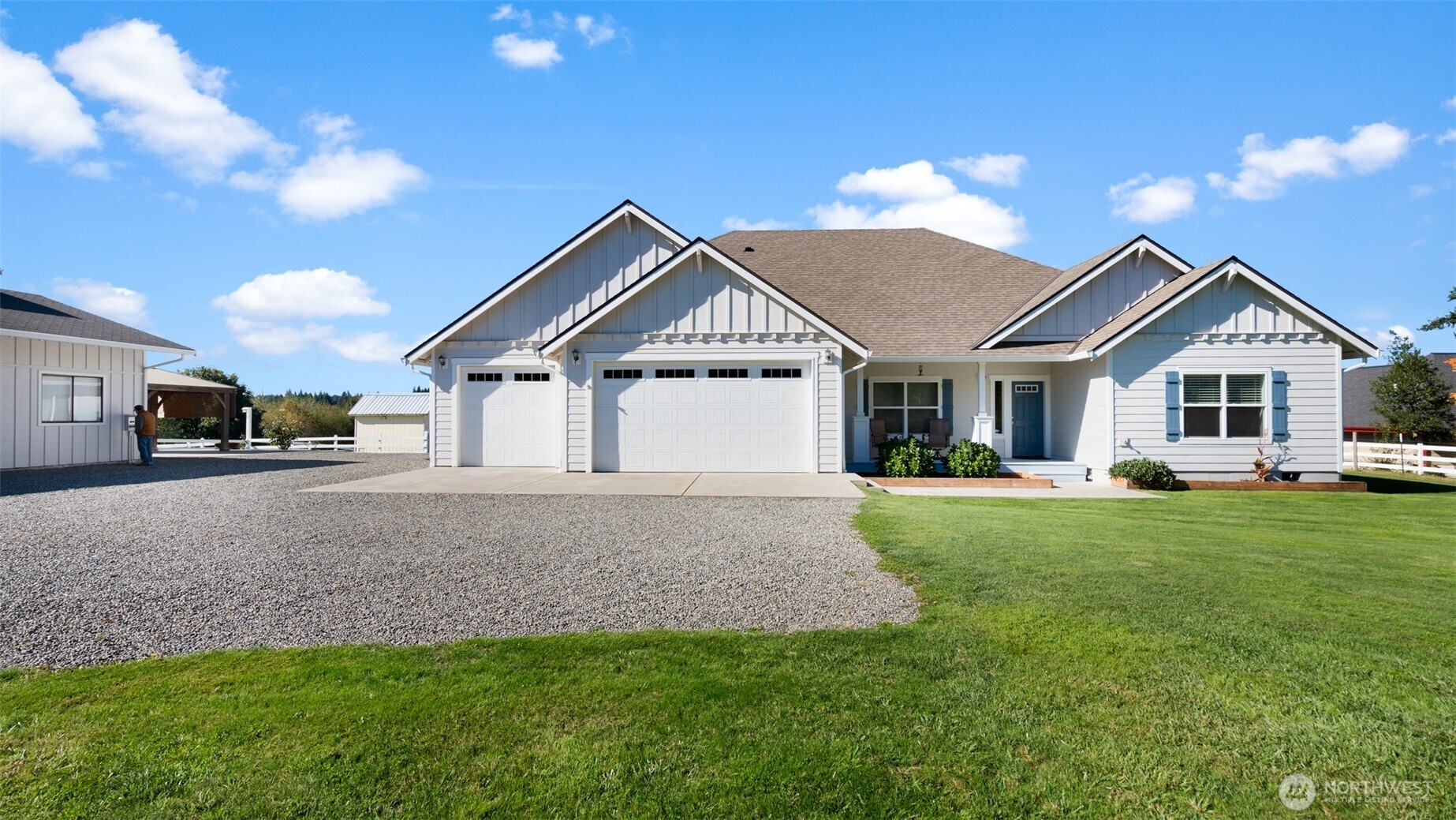 25965 Tytler Road Northeast Poulsbo, WA 98370 - Photo 37 of 40 a front view of a house with a garden and yard