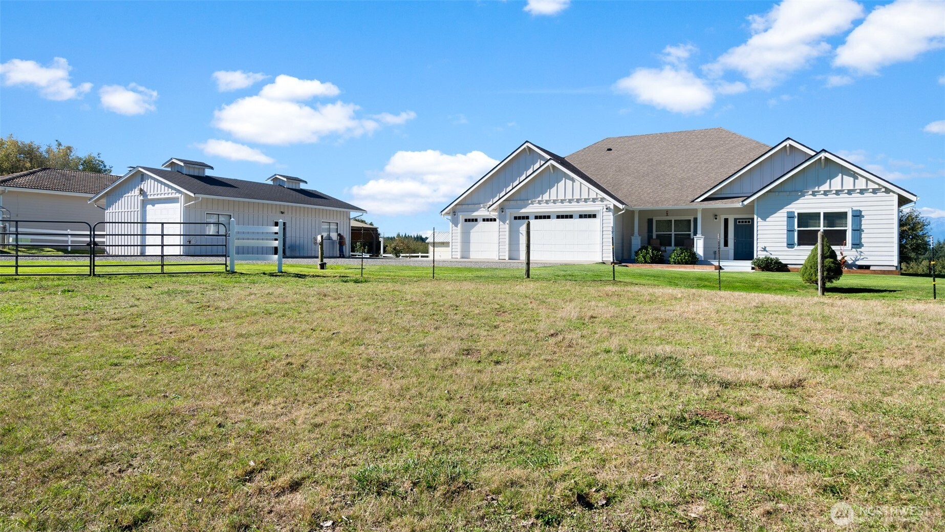 25965 Tytler Road Northeast Poulsbo, WA 98370 - Photo 38 of 40 a front view of a house with a yard