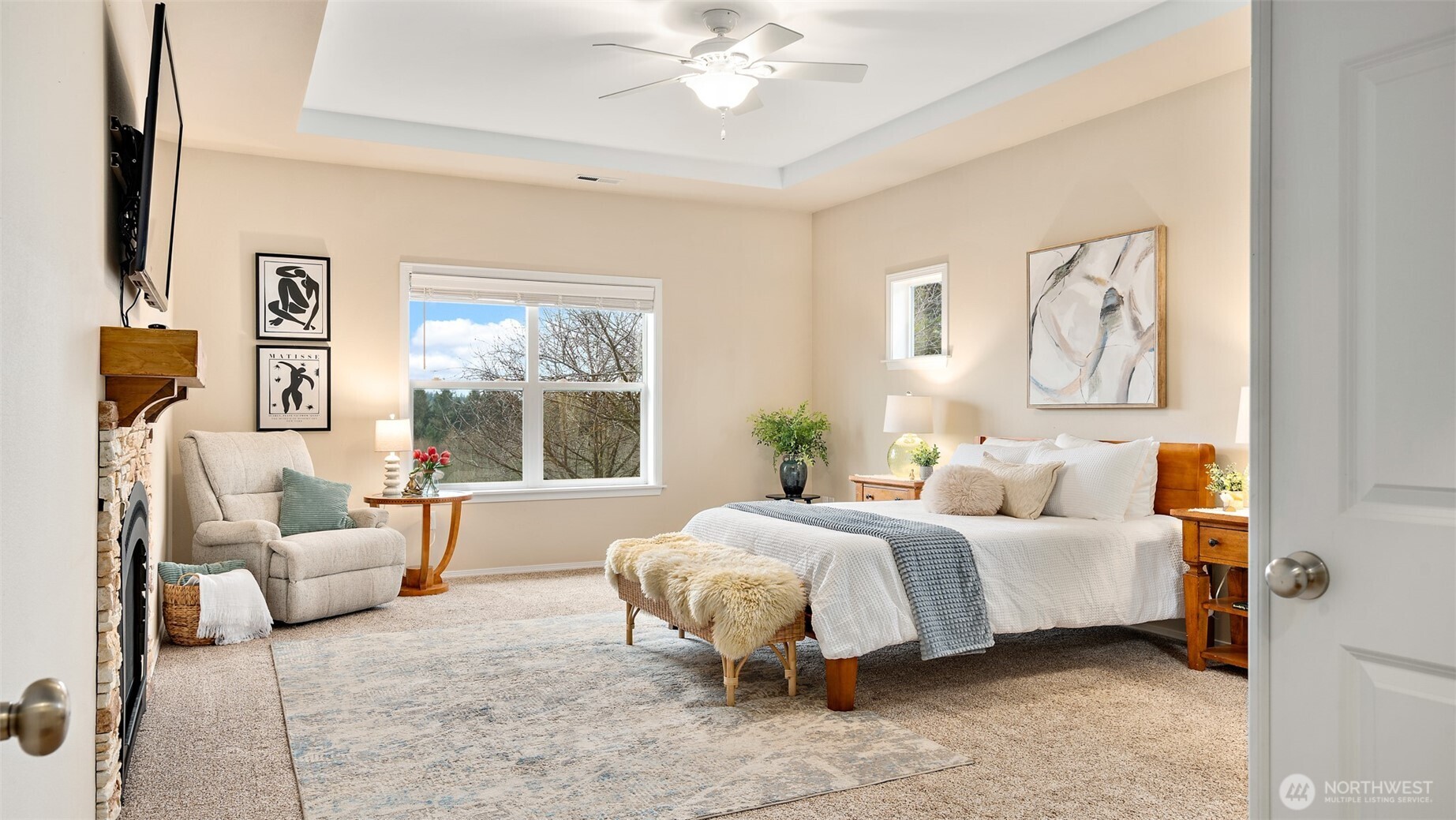 25965 Tytler Road Northeast Poulsbo, WA 98370 - Photo 9 of 40 a bedroom with a bed and a chandelier