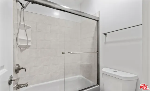 a bathroom with a shower and a toilet