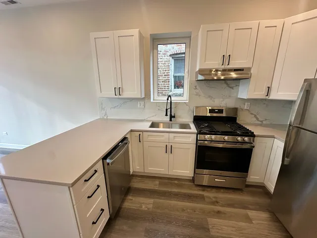 a kitchen with a sink cabinets and stainless steel appliances