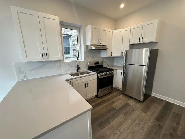 a kitchen with a white stove top oven and refrigerator