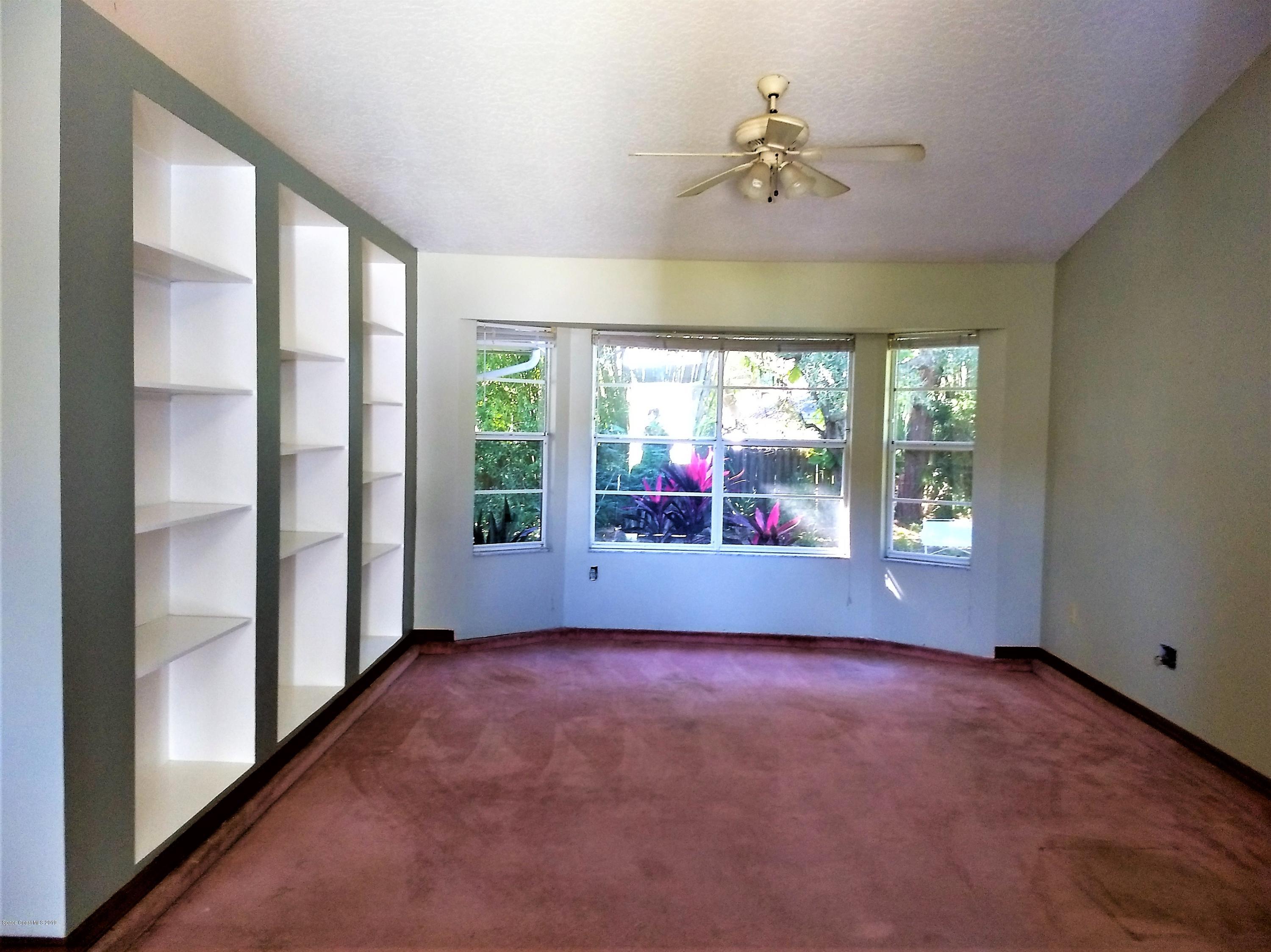 200 Rios Court Southeast Palm Bay, FL 32909 - Photo 16 of 56 Cozy Library with Built In Shelves