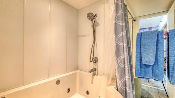 a bathroom with a tub and shower