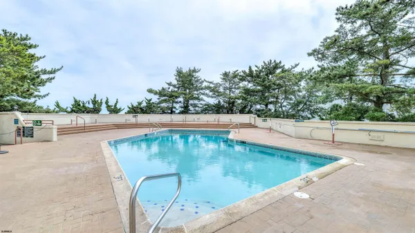 a view of a swimming pool with an outdoor seating