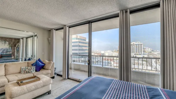 a living room with furniture and a floor to ceiling window
