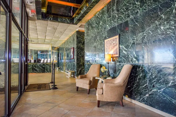 a view of a patio with a table and chairs and floor to ceiling window