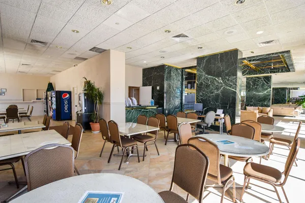 a living room with lots of furniture and a large window