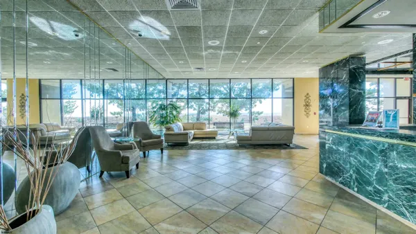 a living room with furniture and a floor to ceiling window