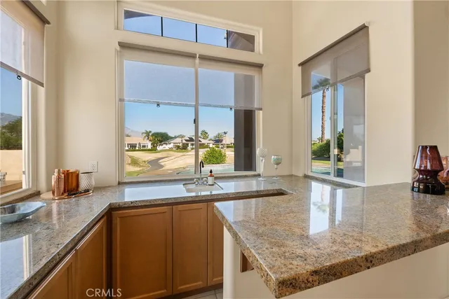 a kitchen with granite countertop a sink and a counter top space