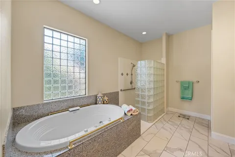 a bathroom with a bathtub and shower