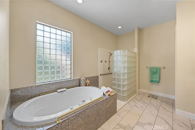 a bathroom with a bathtub and shower