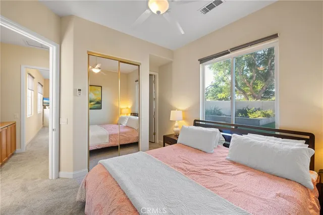 a bedroom with a large bed and a chandelier