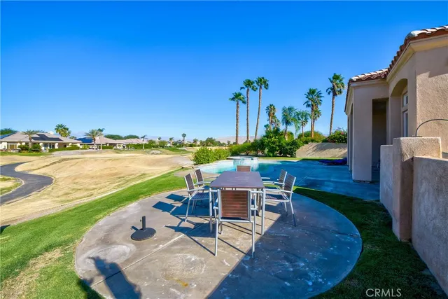 a view of a white house with a sink and a yard