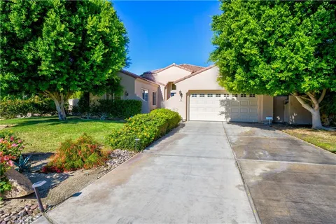 a front view of a house with a yard and a garage